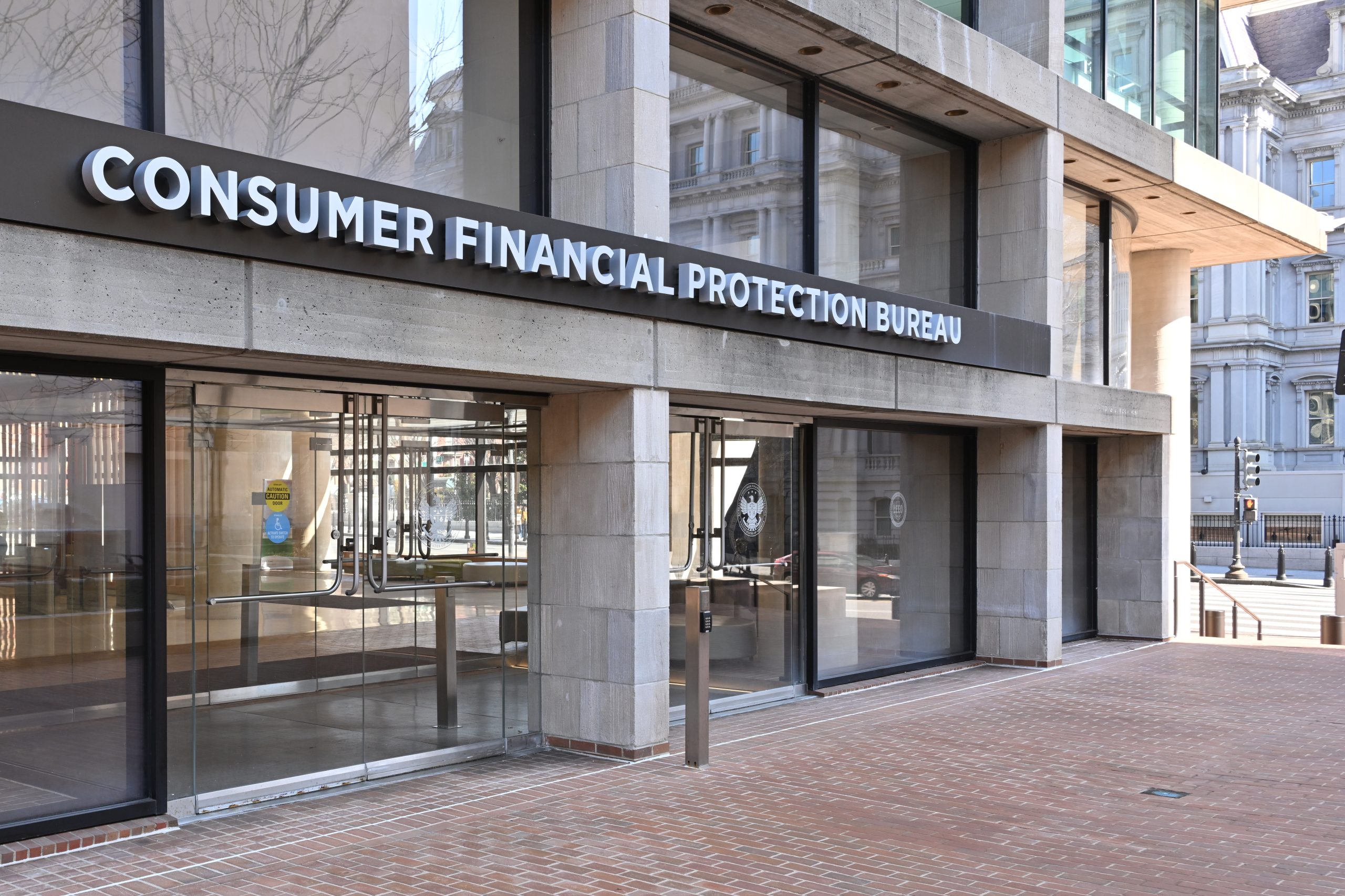 The entrance to the Consumer Financial Protection Bureau headquarters with the bureau's name above it. 